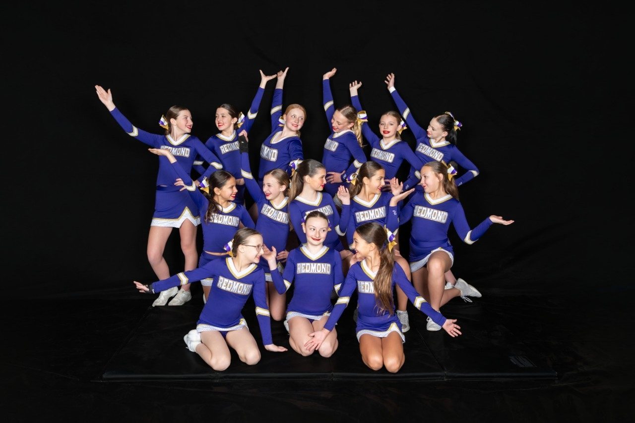 Gold team posed celebrating in a studio photo
